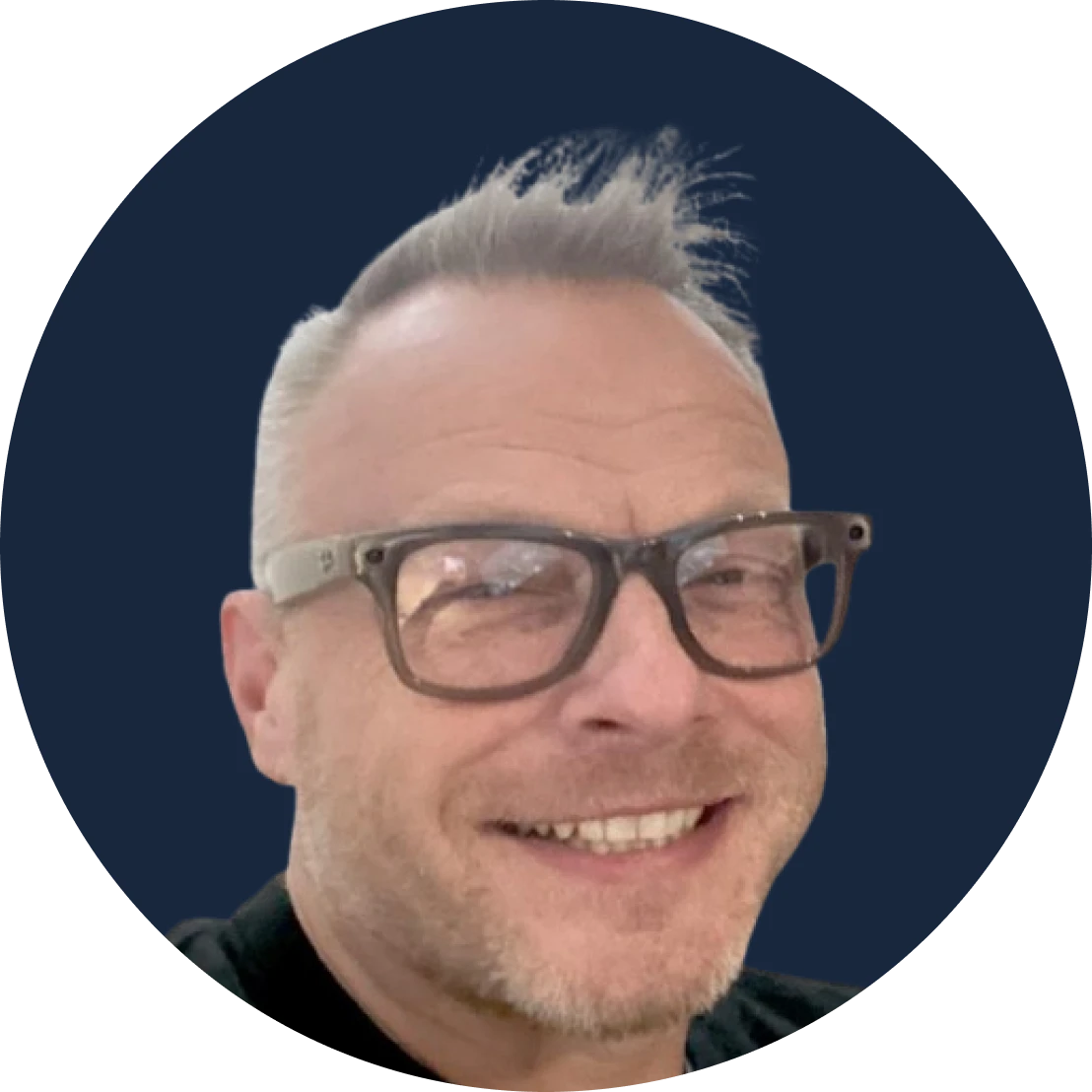 smiling man with glasses in a circular navy avatar background on profile photo